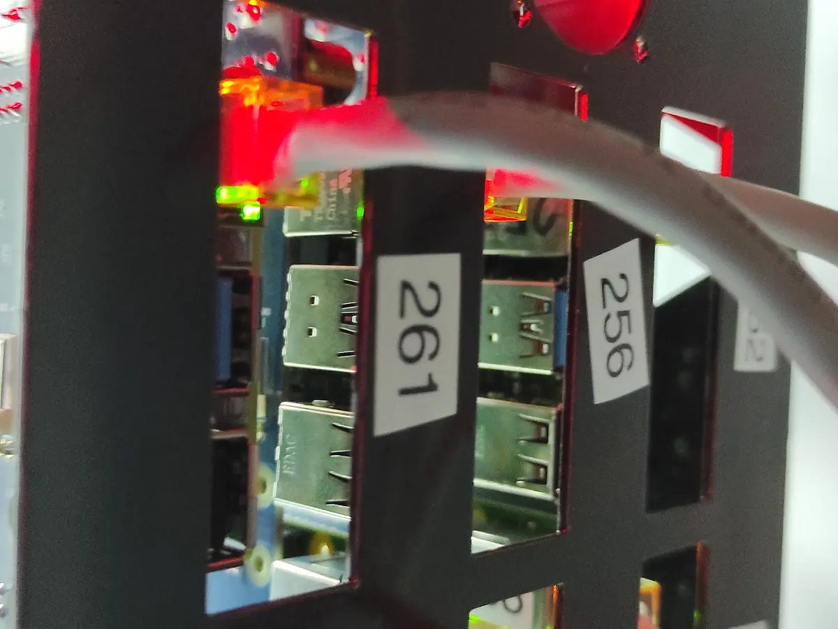 Customers' Raspberry Pi boards in numbered rack slots 256 and 261, power LEDs on