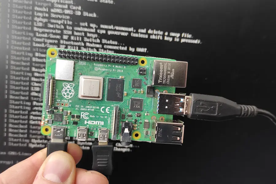 A connected Raspberry Pi 4 with a boot log on the screen behind it